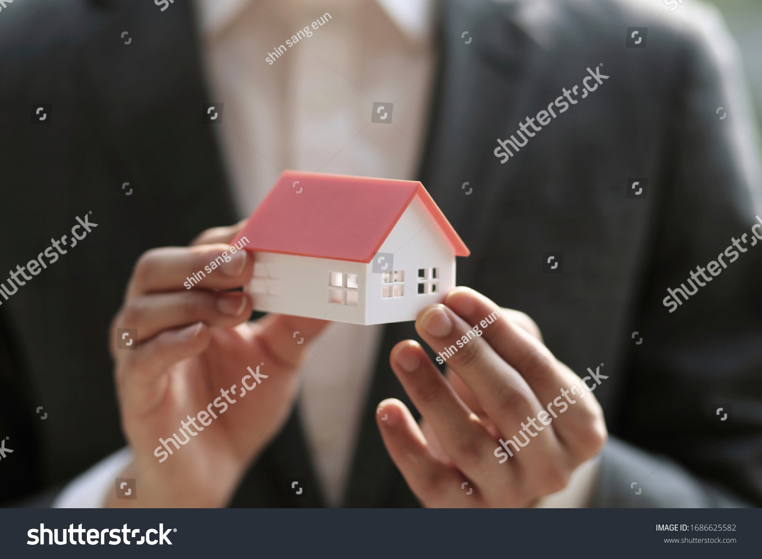Close up of businessman holding model house. Architecture, building, construction, real estate and property concept 
 #1686625582