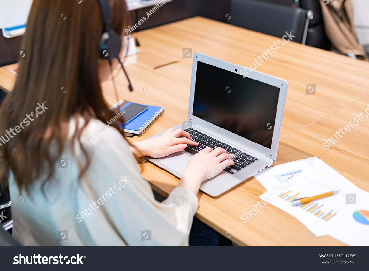 Business woman teleworking in conference room #1687112569