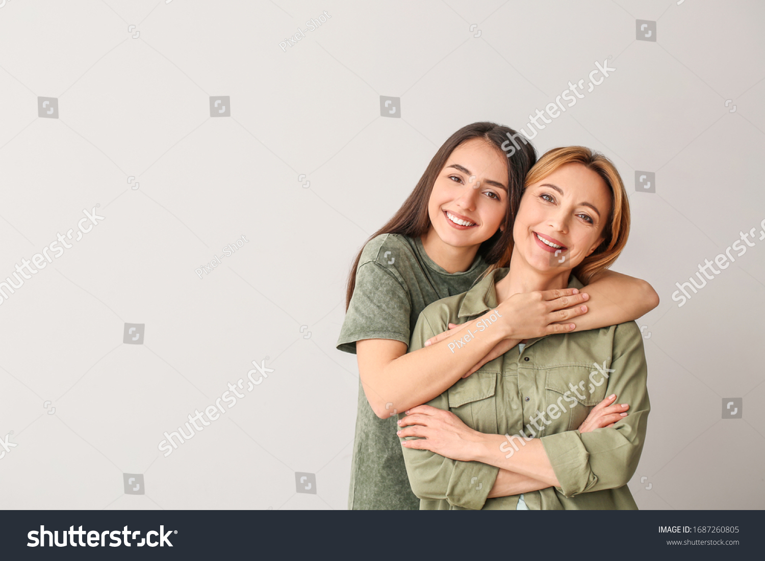 Portrait of young woman and mother on grey background #1687260805