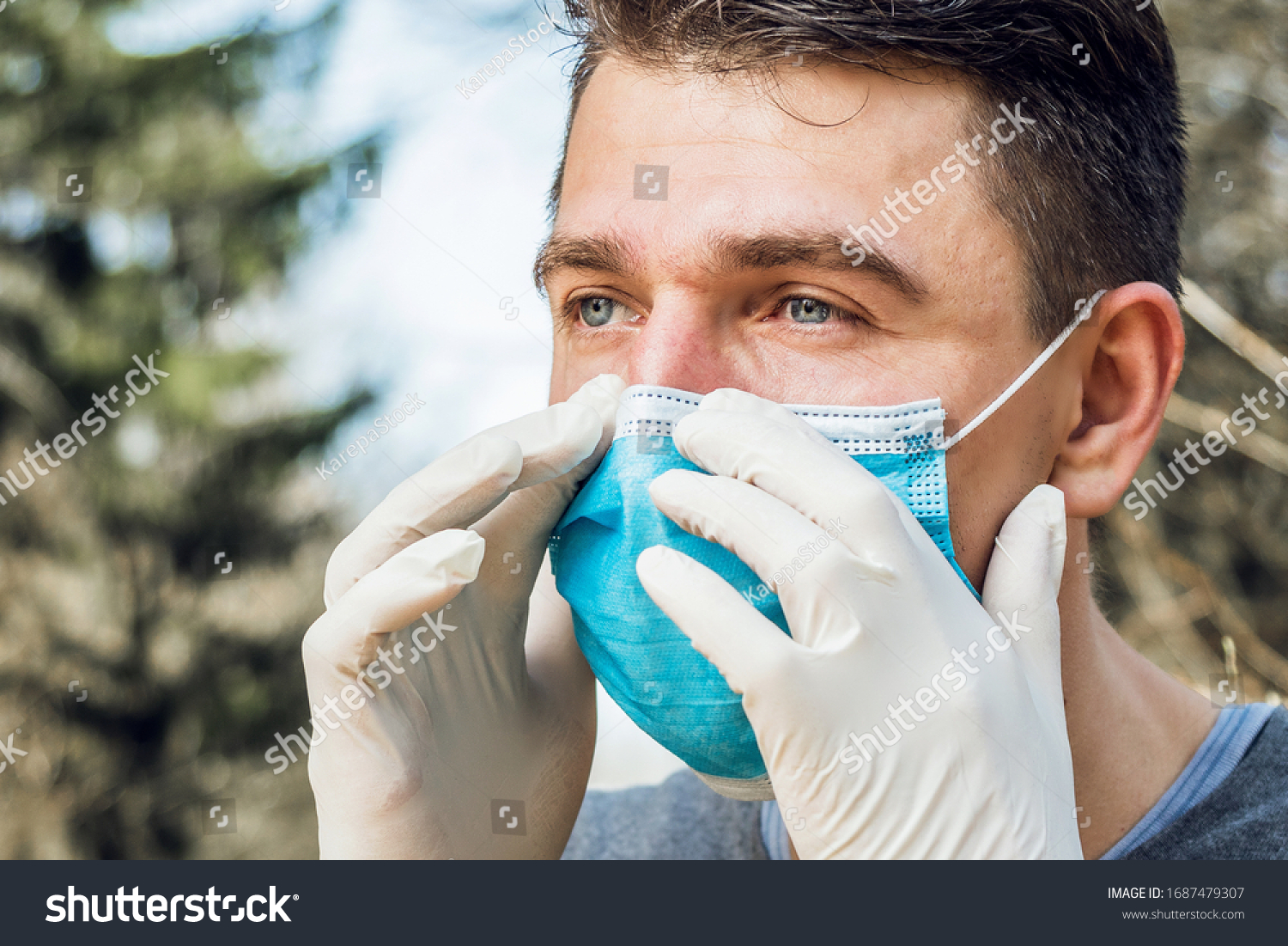 Portrait of man wearing a protective mask, walking in the Park. Corona Virus Protection. #1687479307