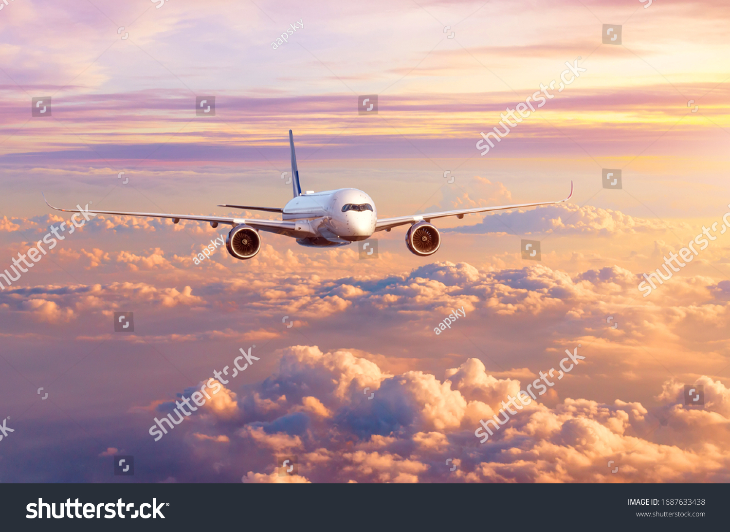 Airplane airliner flies over beautiful evening clouds, in the sky at sunset #1687633438