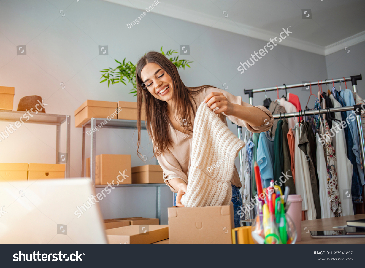 Woman Running Business From Home. Shipping shopping online, young start up small business owner packing cardboard box at workplace. Online selling or e-commerce. #1687940857