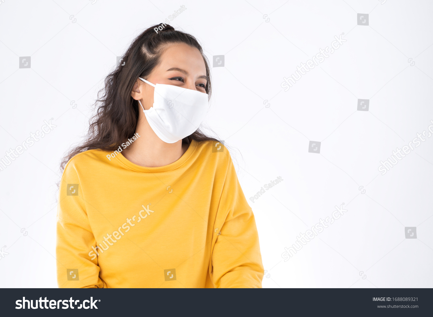Young happy Asian woman wearing hygienic mask to prevent infection corona virus Air pollution pm2.5 she wearing a yellow sweater shoot in shot isolated on white background #1688089321