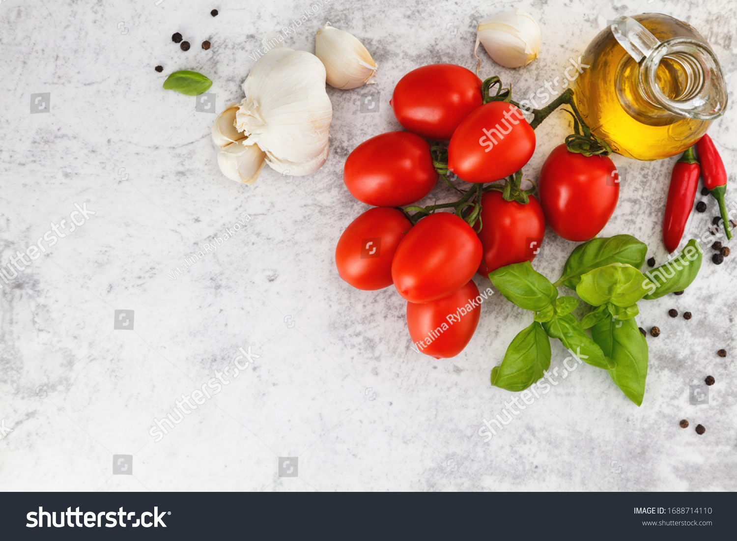 Fresh colorful tomatoes, basil and olive oil on white table. Top view with copy space
 #1688714110
