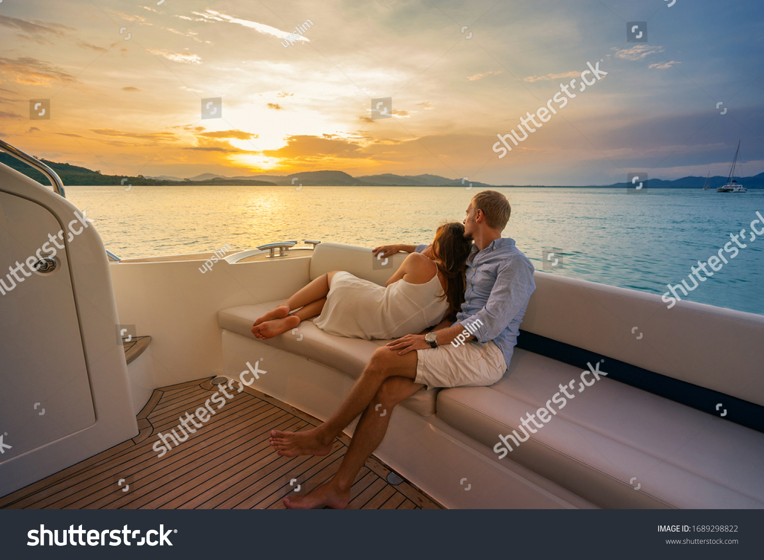 Romantic vacation . Beautiful couple looking in sunset from the yacht. #1689298822