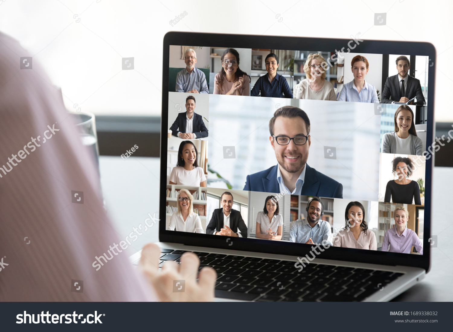 Close up of employee talk on video call on laptop with diverse colleagues, worker speak on web conference with multiracial coworkers, have online briefing with team, use Webcam on computer #1689338032
