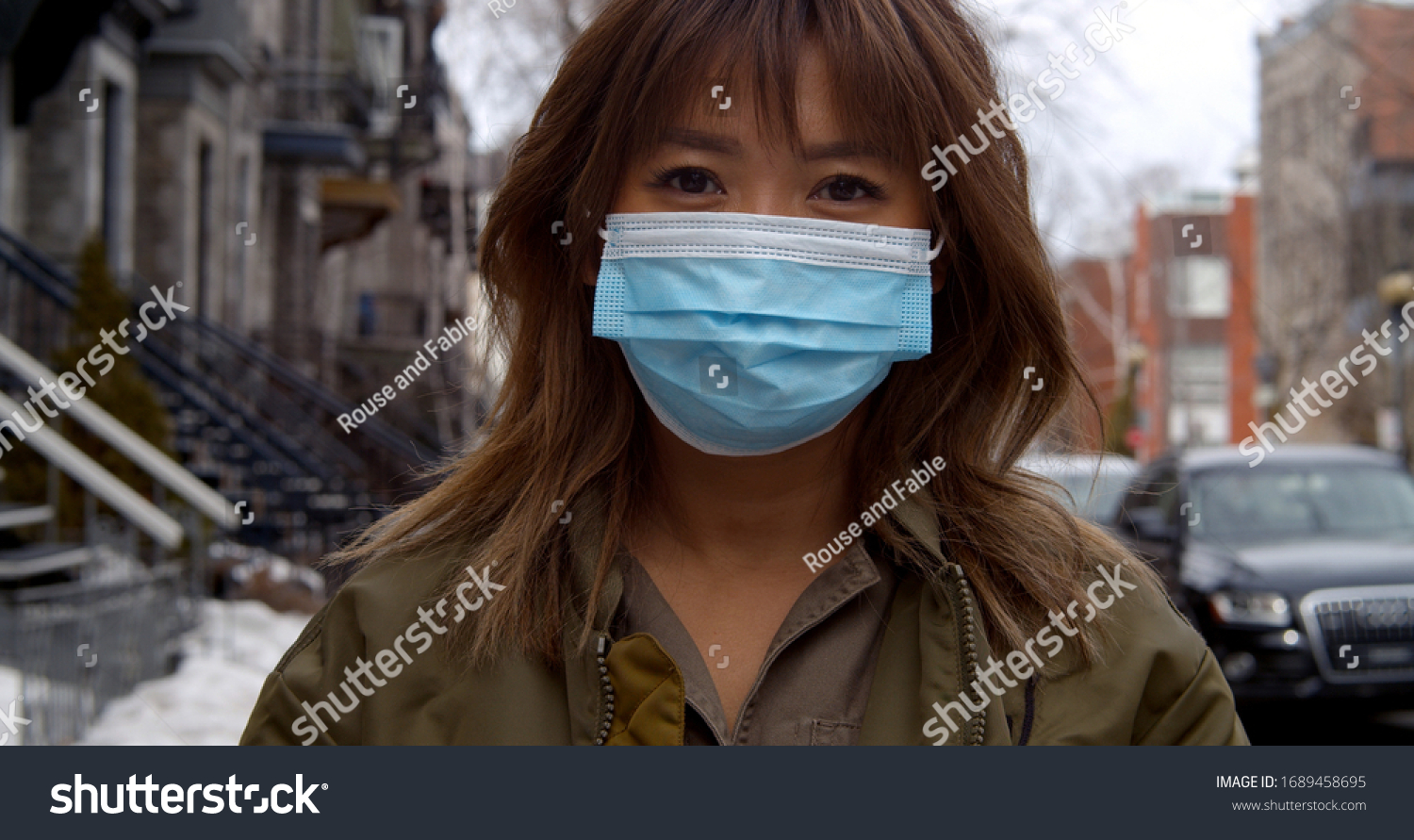 Portrait of woman wearing face mask  during coronavirus pandemic protecting herself against pathogens #1689458695