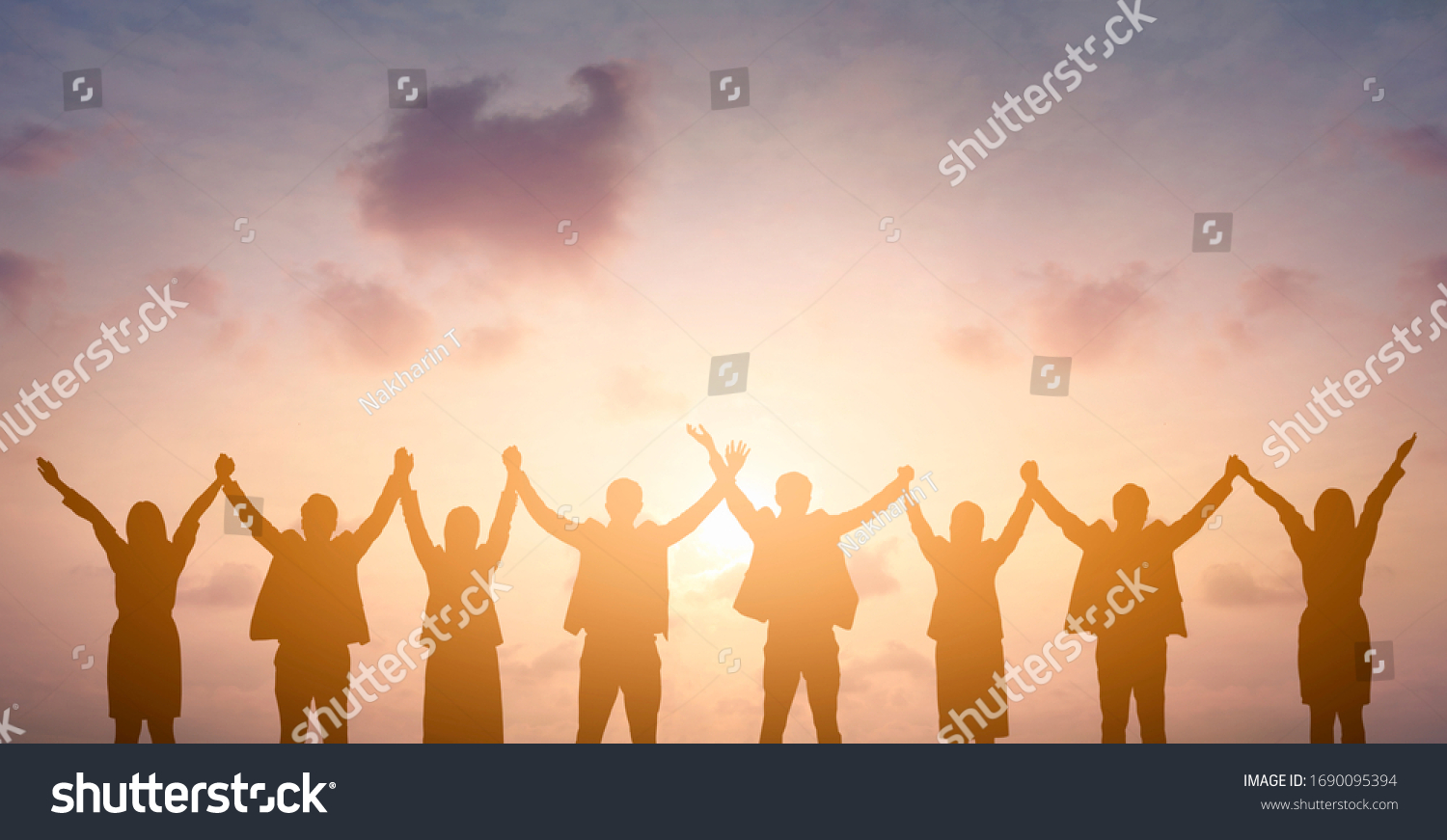Silhouette of happy business teamwork making high hands over head in sunset sky background for business teamwork concept #1690095394