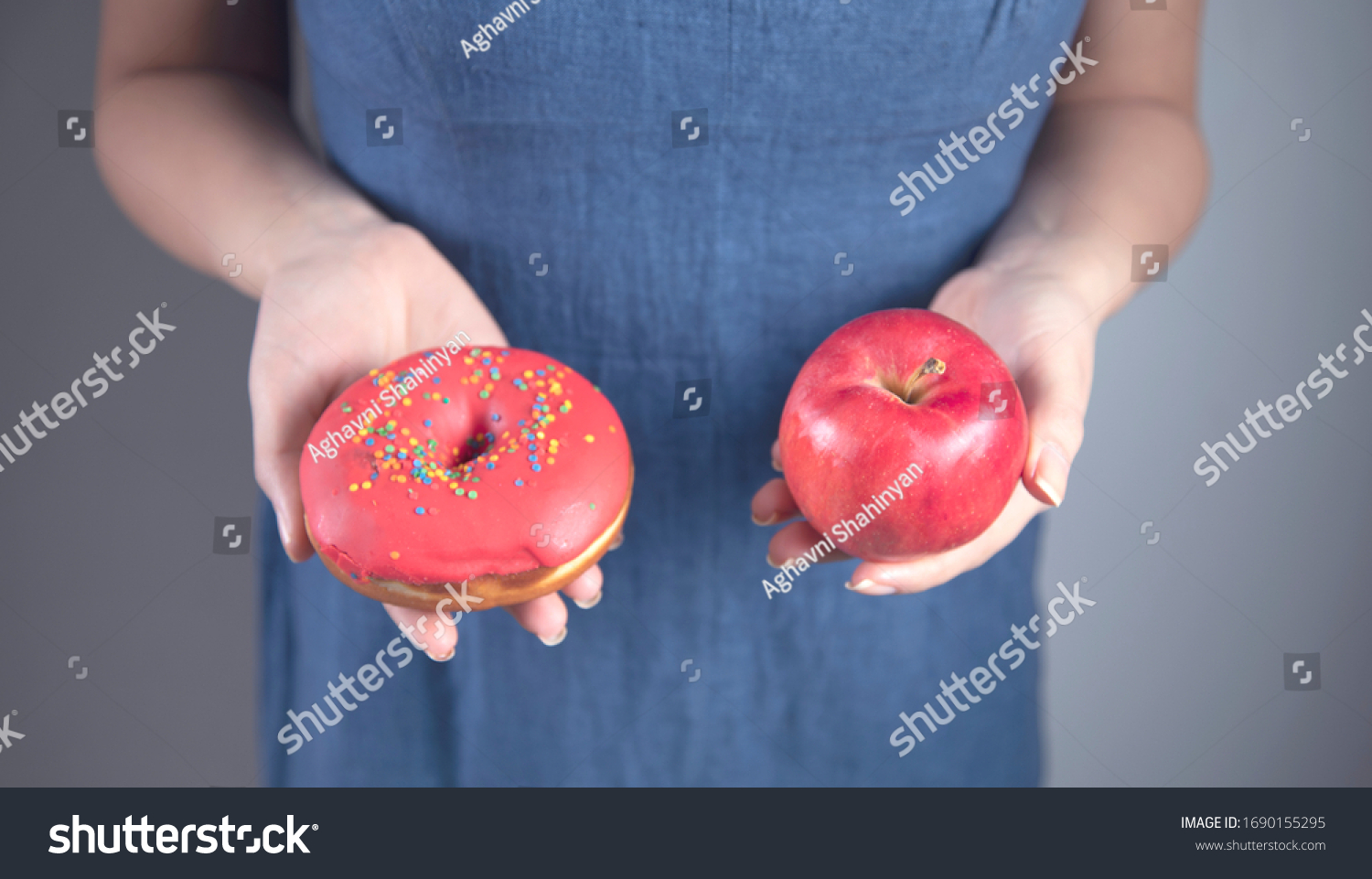 happy woman hand holding Donut and apple #1690155295