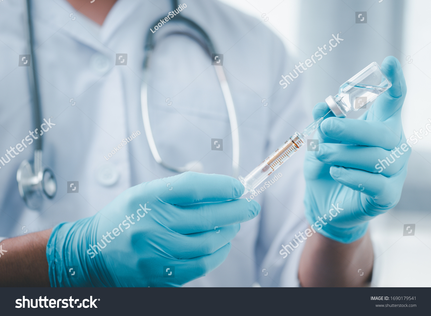 Concept fight against virus covid-19 corona virus, doctor or scientist in laboratory holding a syringe with liquid vaccines for children or older adults,Concept:diseases,medical care,science. #1690179541