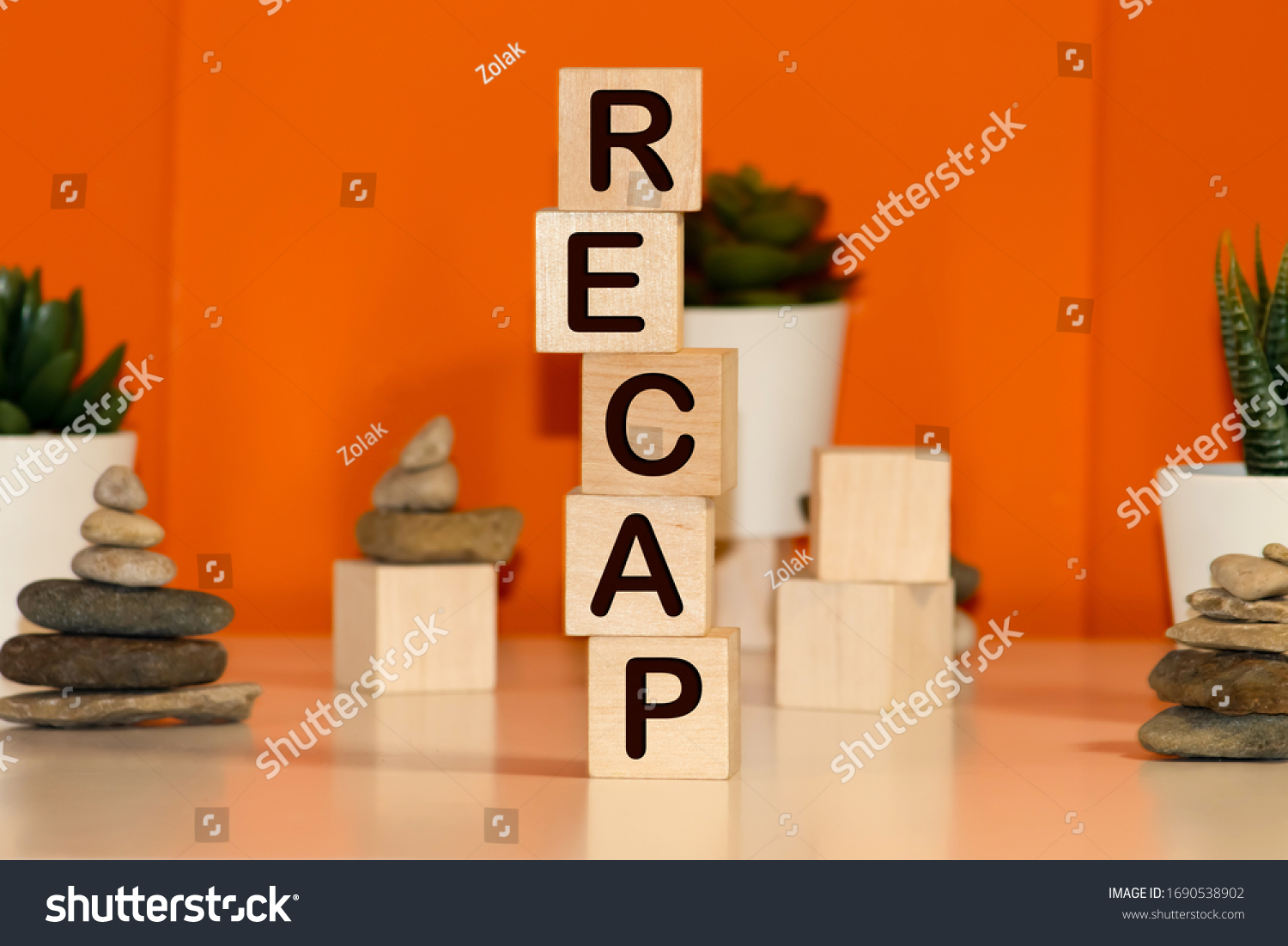 Recap word from wooden blocks on desk #1690538902
