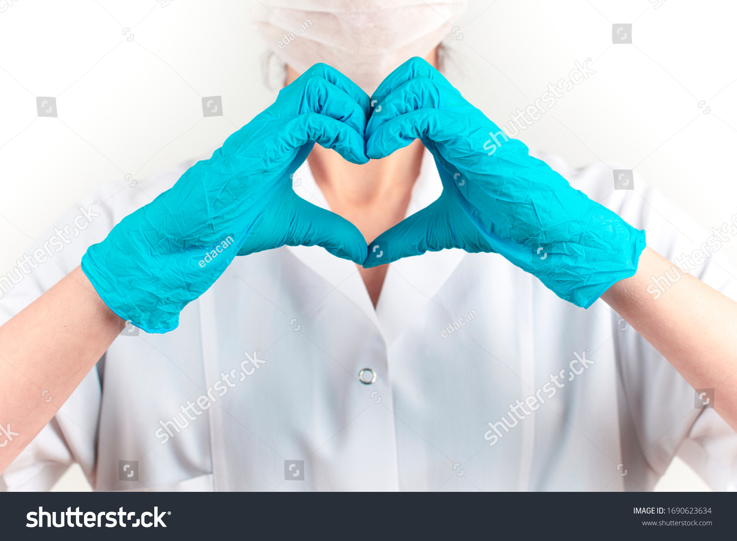 young female doctor in medicine mask is making a heart sign. White background
 #1690623634