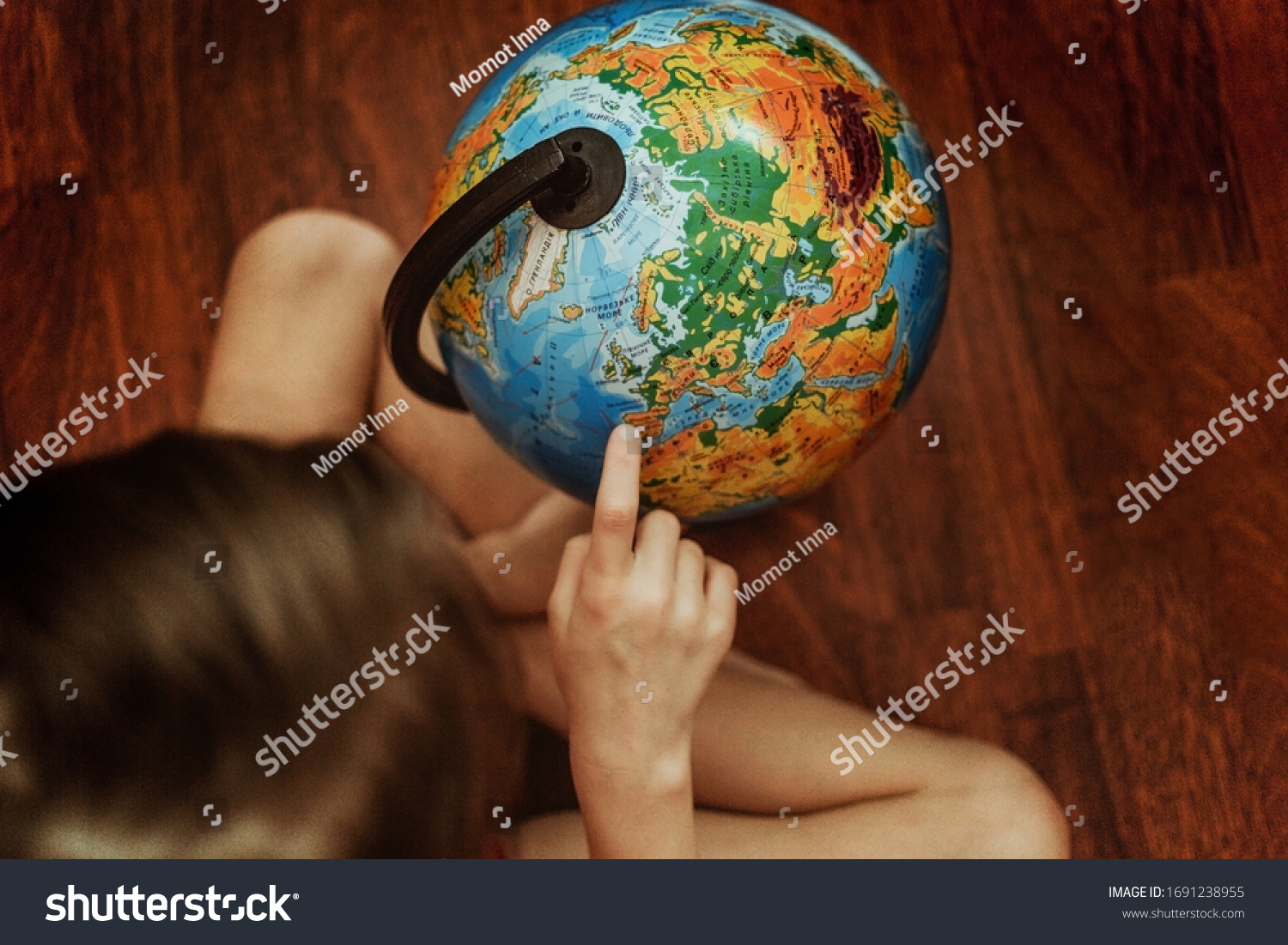 girl explores the globe. home schooling. research. distance learning. continents. Save  people  the planet, peace, love, life and environmental concept. Earth Day. View from above.Ecology #1691238955
