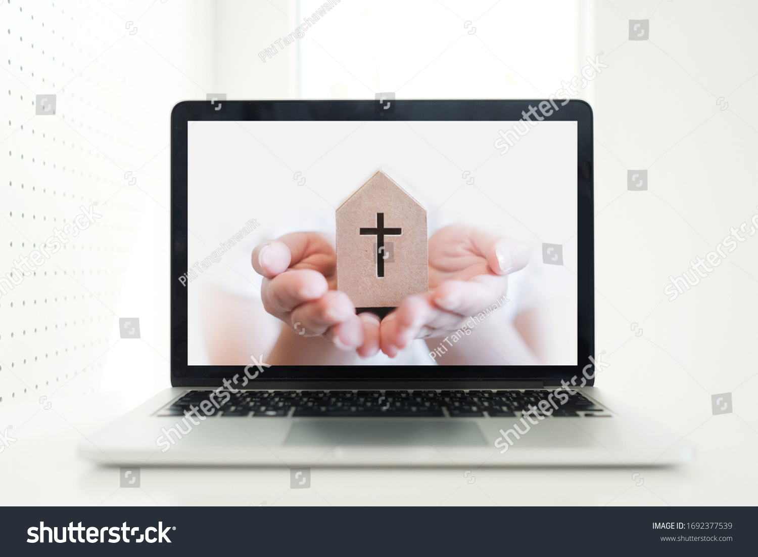 Church services online concept, Home church during quarantine coronavirus Covid-19, Online church from home new normal concept, Cross with hand pop up from screen laptop, spirituality and religion #1692377539