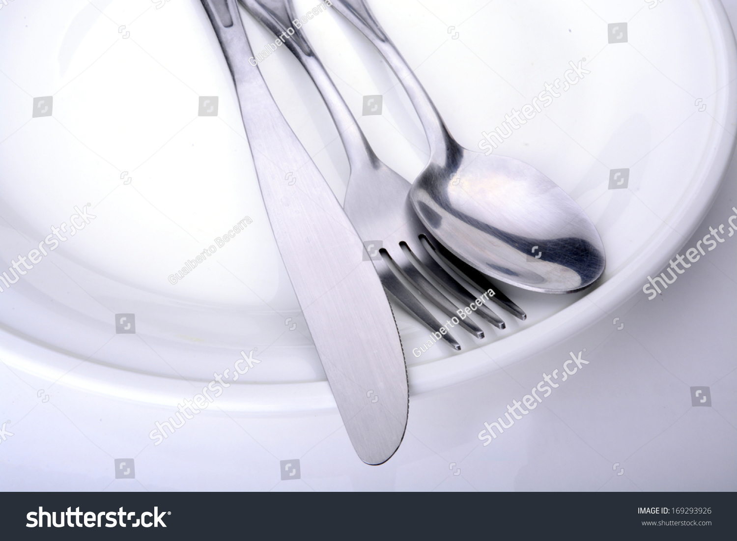 Macro shot of a white plate with utensils on it #169293926
