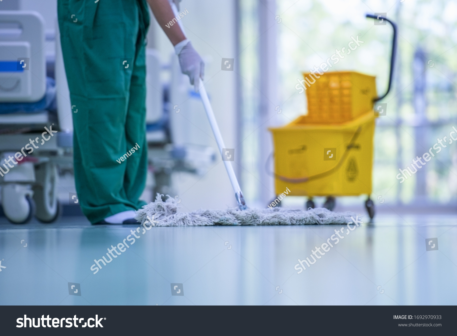 Blurred hospital images, Clean and sanitize, Cleaner, Hospital cleaning,Cleaning the hospital floor. Floor care and cleaning services with washing mop in sterile factory or clean hospital. #1692970933
