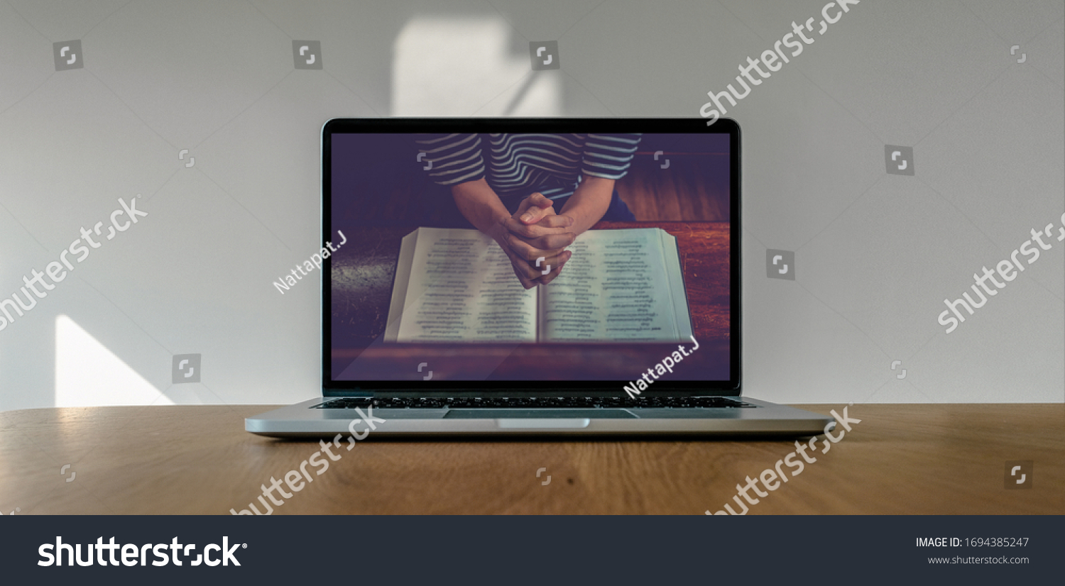 Worship from home, Online live church for sunday service, Laptop screen with close up prayer hands, quarantine for Covid 19 situation #1694385247