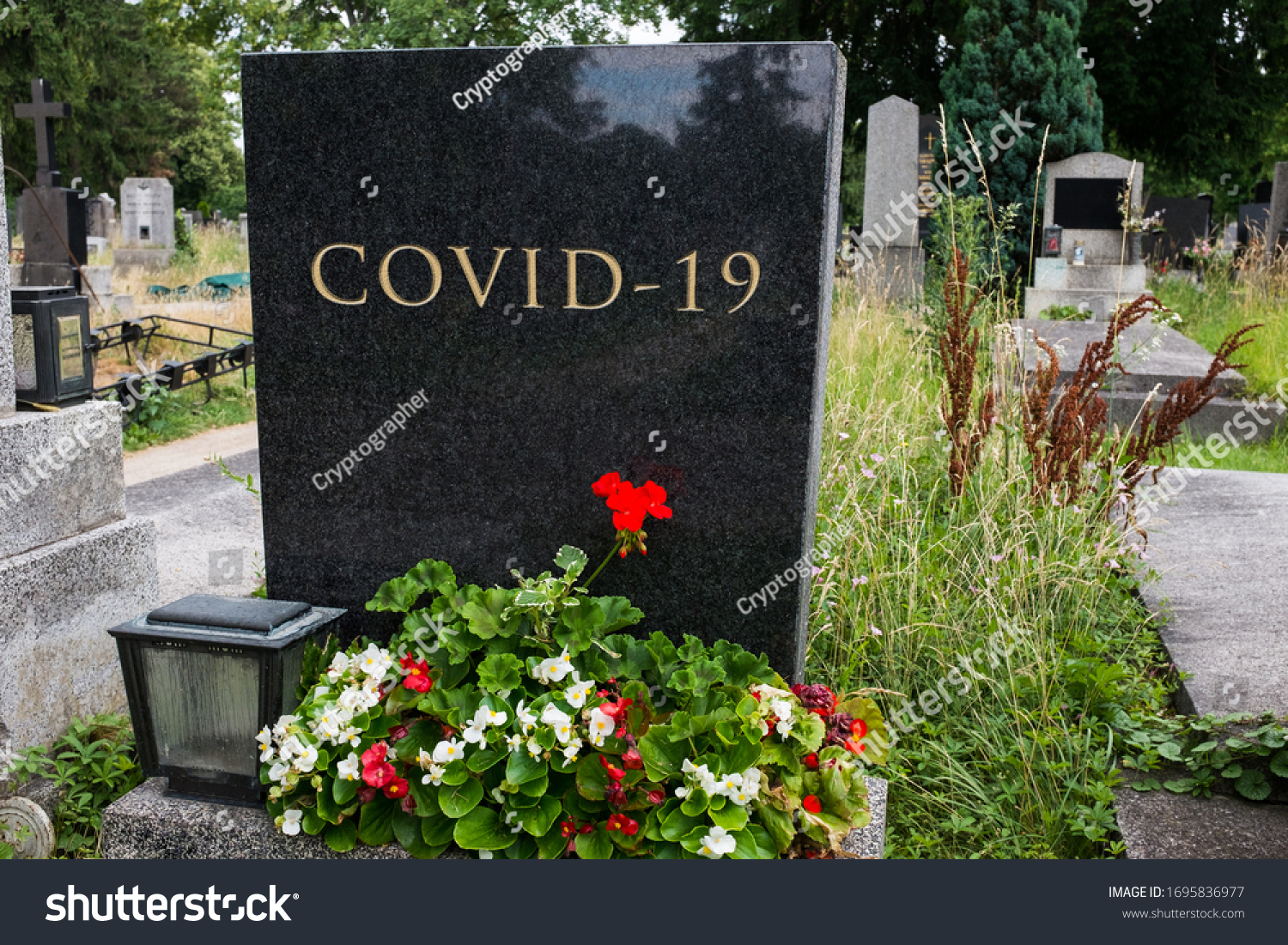 Graveyard cemetery black granite headstone with COVID-19 letters carved in, Coronavirus pandemic crisis taking many lives, deadly virus death toll rising, high mortality rate, acute pneumonia victims #1695836977