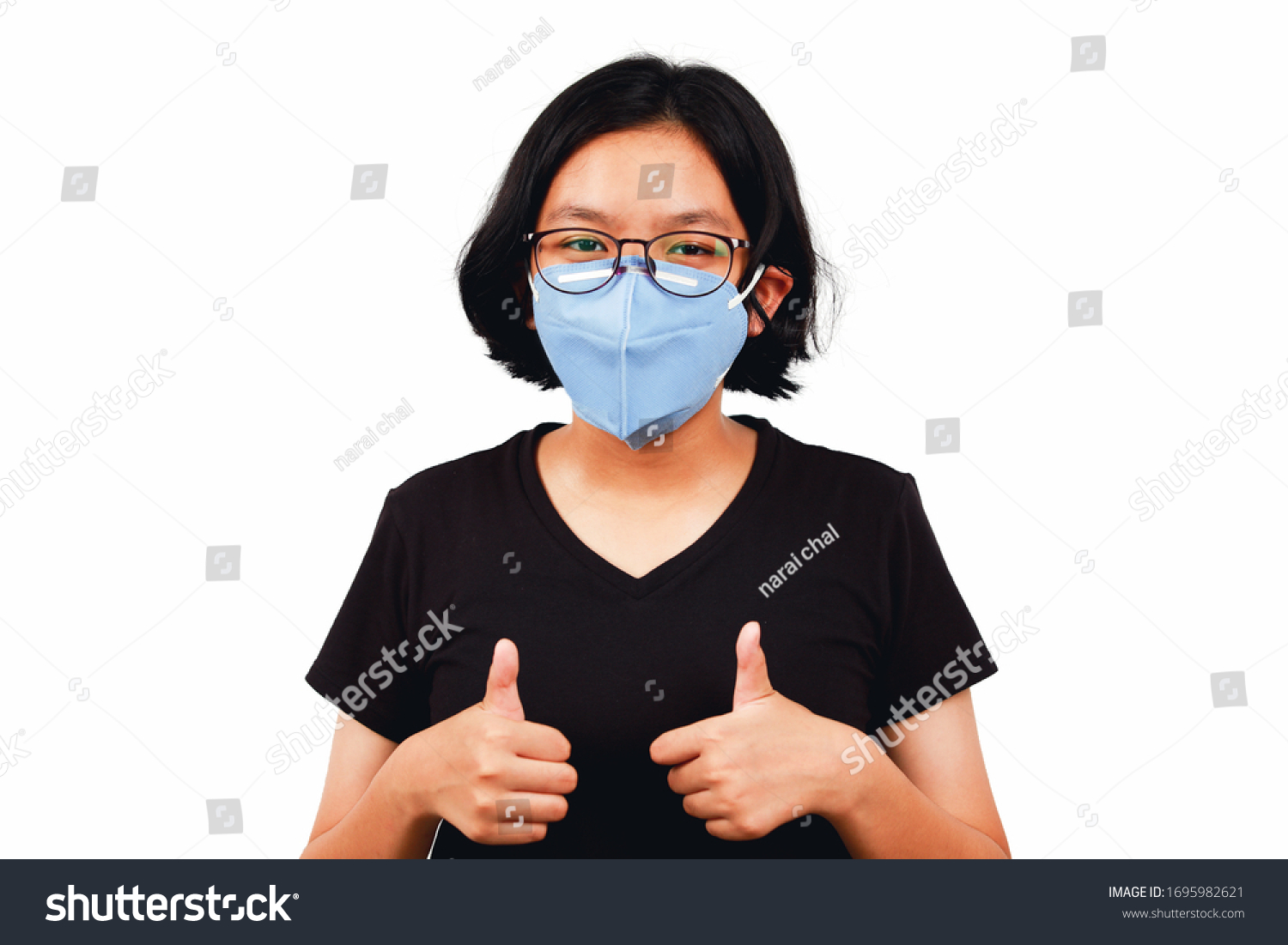 Young girl wear mask and thump up to flighting corona virus or Covid-19 #1695982621