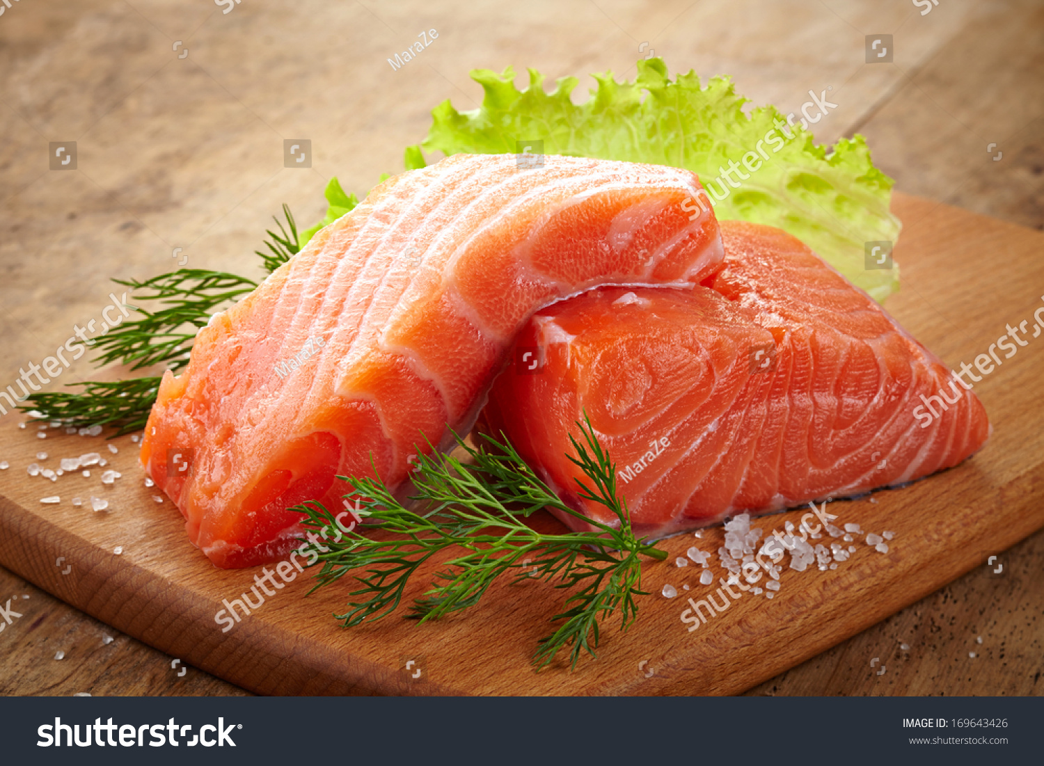 fresh raw salmon on wooden cutting board #169643426