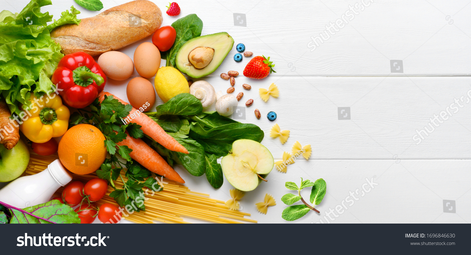 Healthy food background. Food photography different fruits and vegetables on white wooden table background. Copy space. Shopping food in supermarket #1696846630