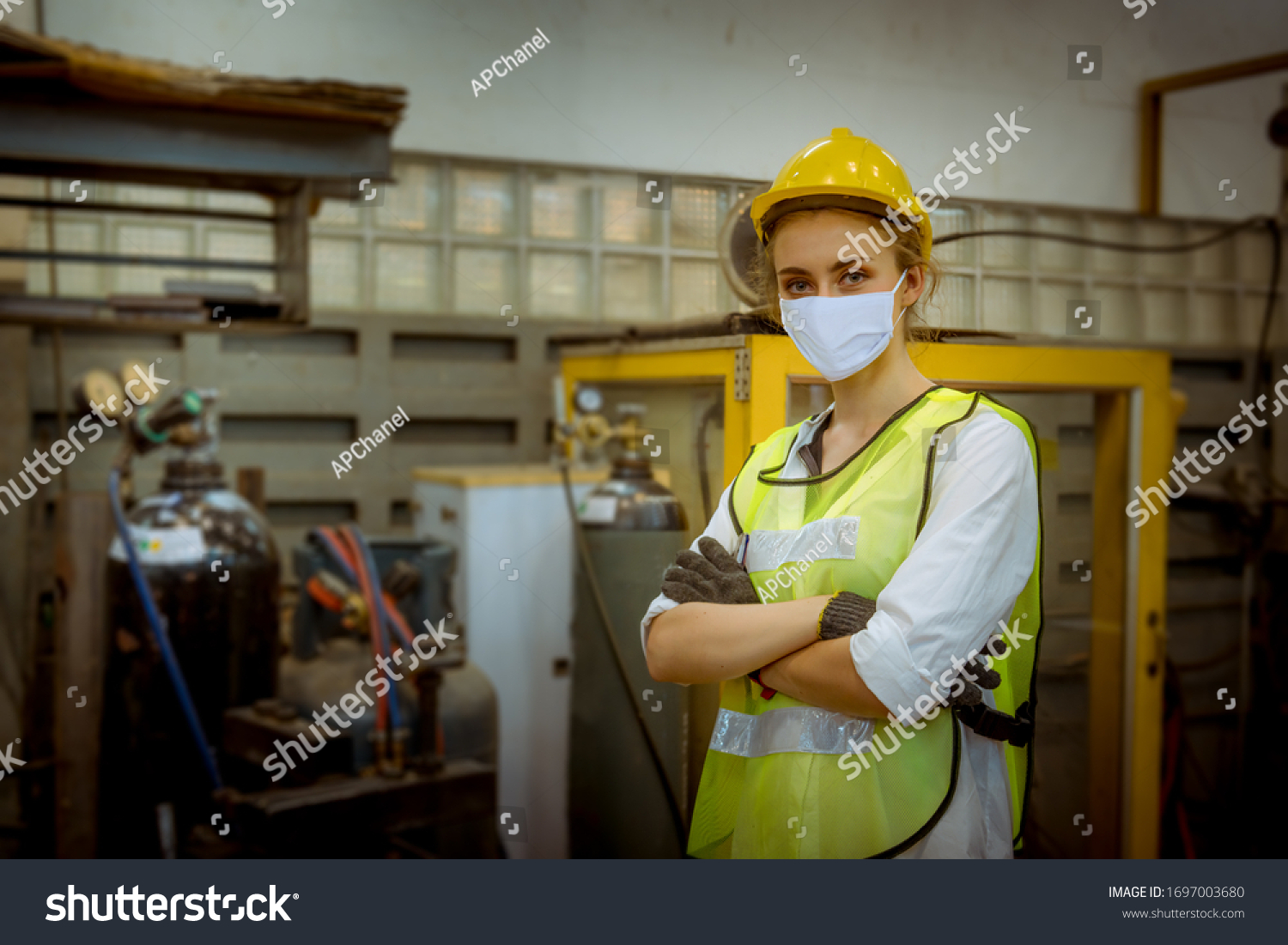 Portrait woman worker under inspection and checking production process on factory station by wearing safety mask face to protect for pollution and virus in factory. #1697003680