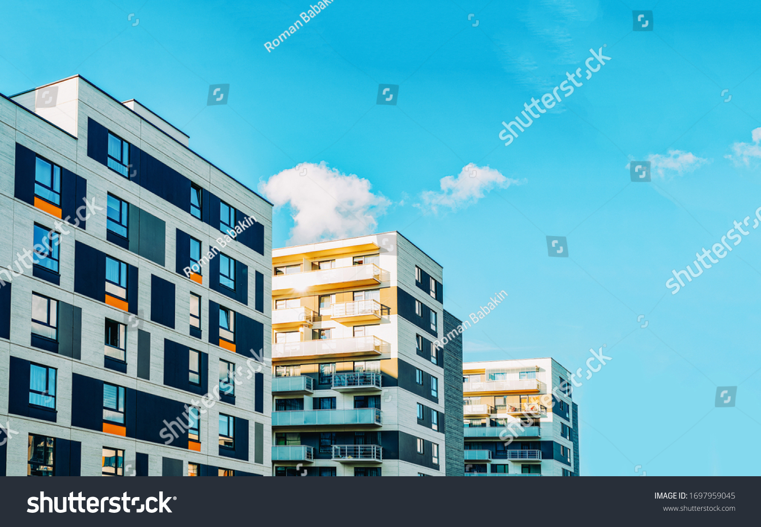 Detail in Modern residential flat apartment building exterior. Fragment of New luxury house and home complex. Part of City Real estate property and condo architecture. Copy space. Blue sky #1697959045