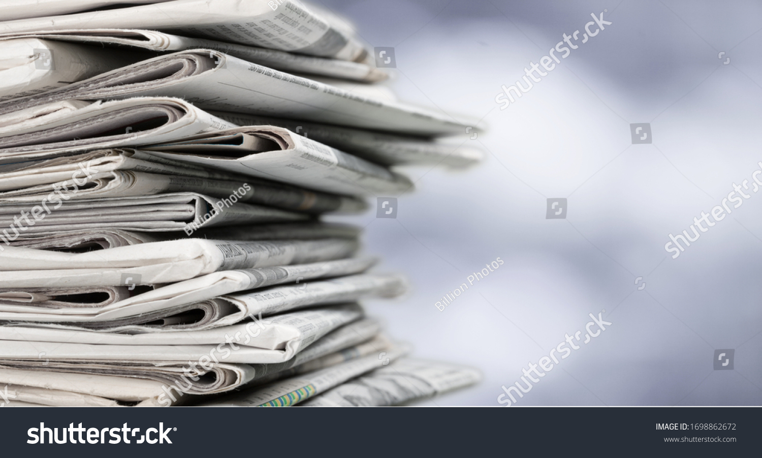 Pile of newspapers on blur background #1698862672