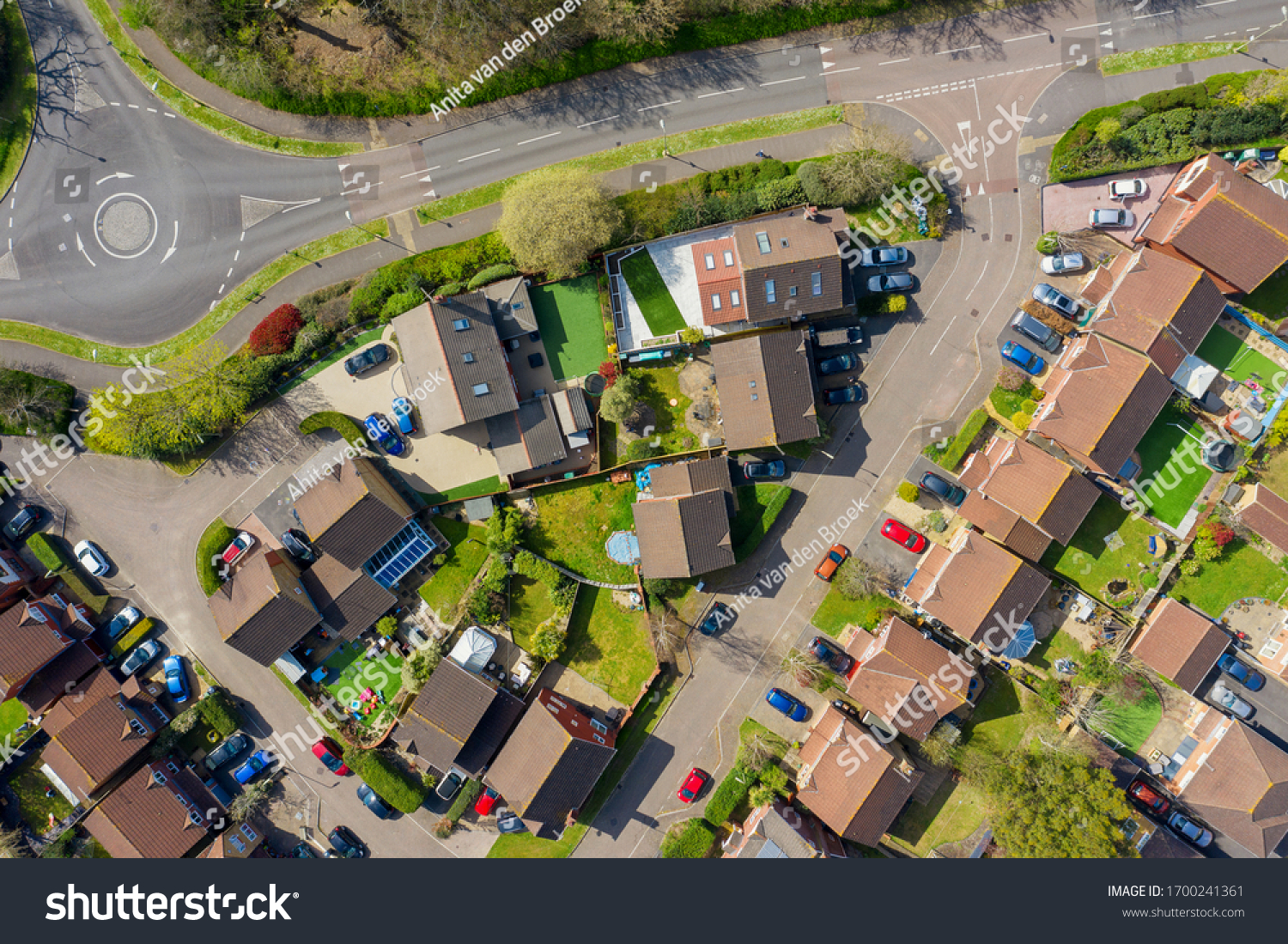 Houses on a housing estate in Hampshire, United Kingdom with deserted streets during lockdown quarantine for Coranavirus Covid 19. All cars are parked and no cars are moving. On a sunny day #1700241361