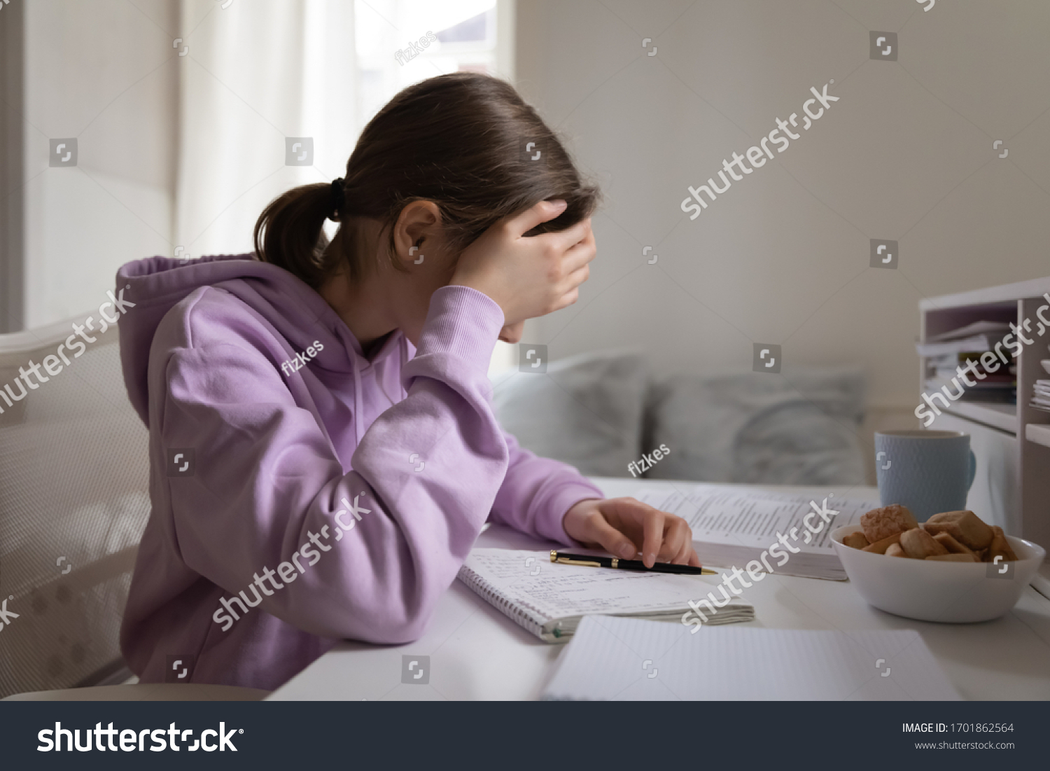 Tired bored teenage kid girl school student feeling headache or fatigue doing homework at home. Exhausted depressed sick teenager studying alone worried about difficult education problems concept. #1701862564