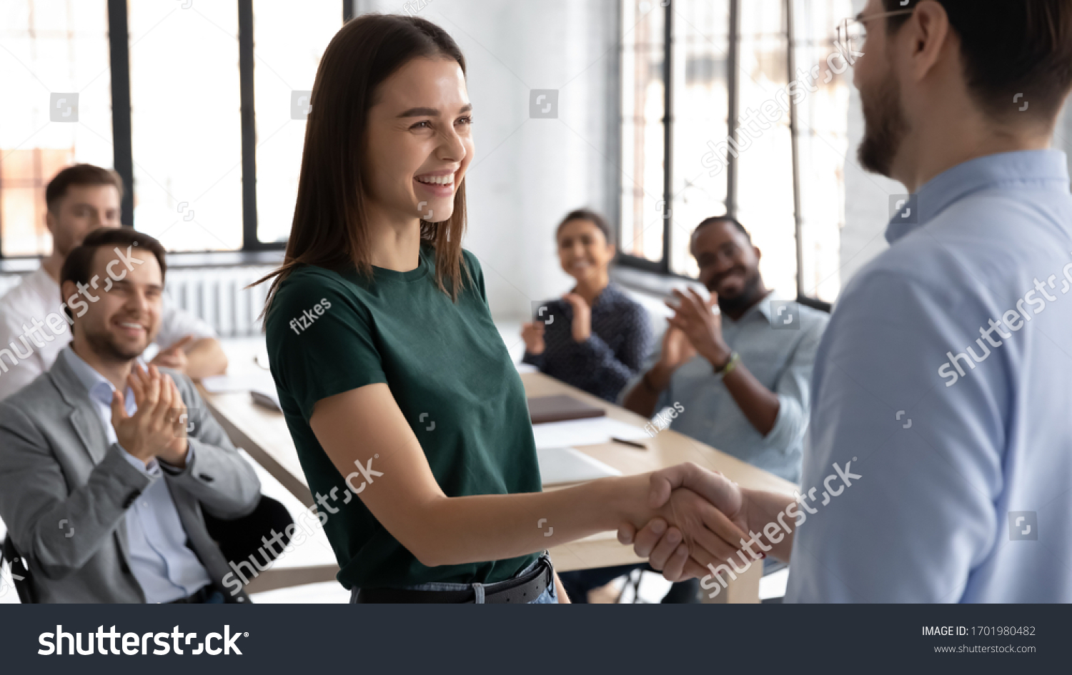 Businessman shake hand of excited Caucasian female employee greeting with achievement or success at office meeting, male boss or CEO handshake happy woman worker congratulate with work promotion #1701980482