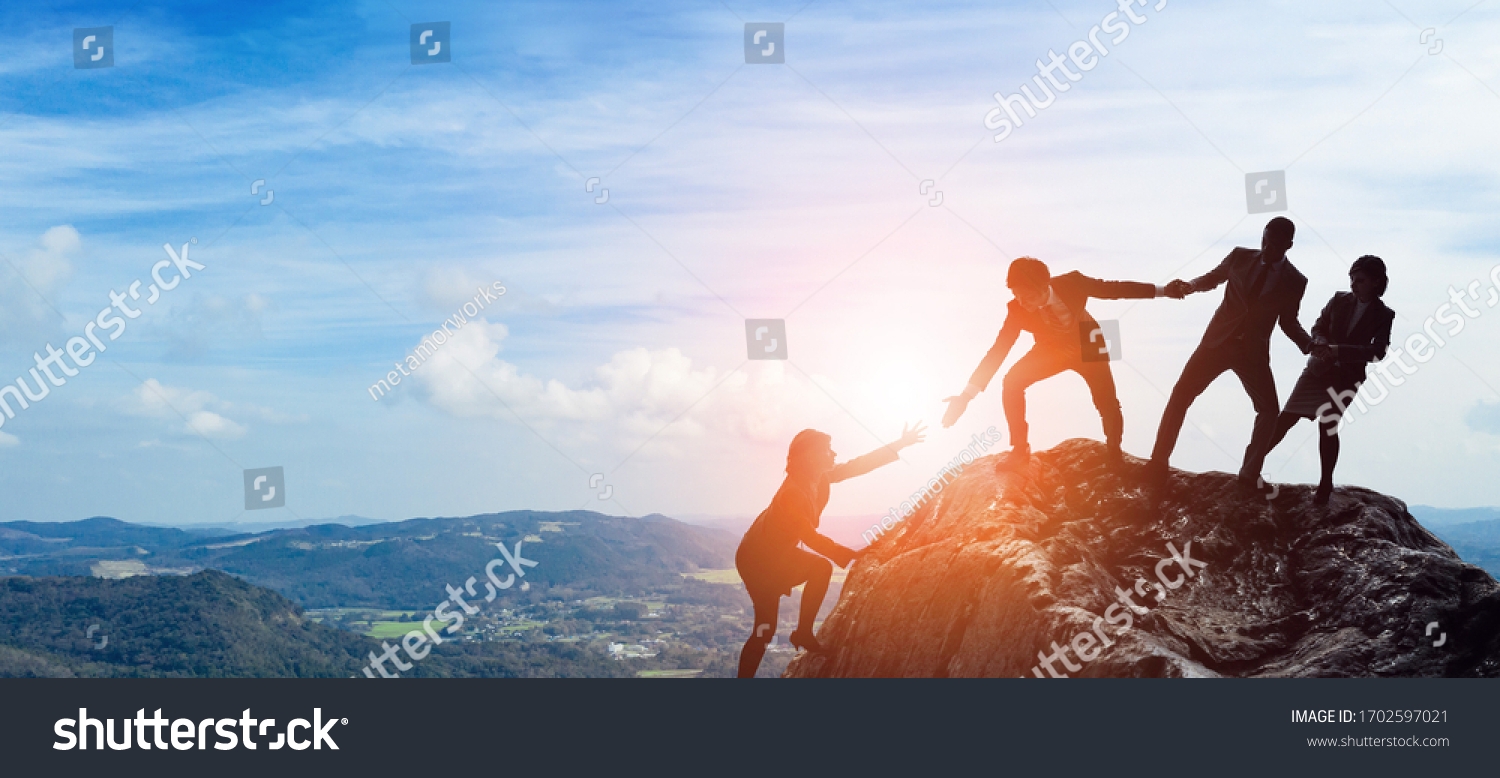 Success of business concept. Partnership of business. Group of businessperson on the mountaintop. #1702597021