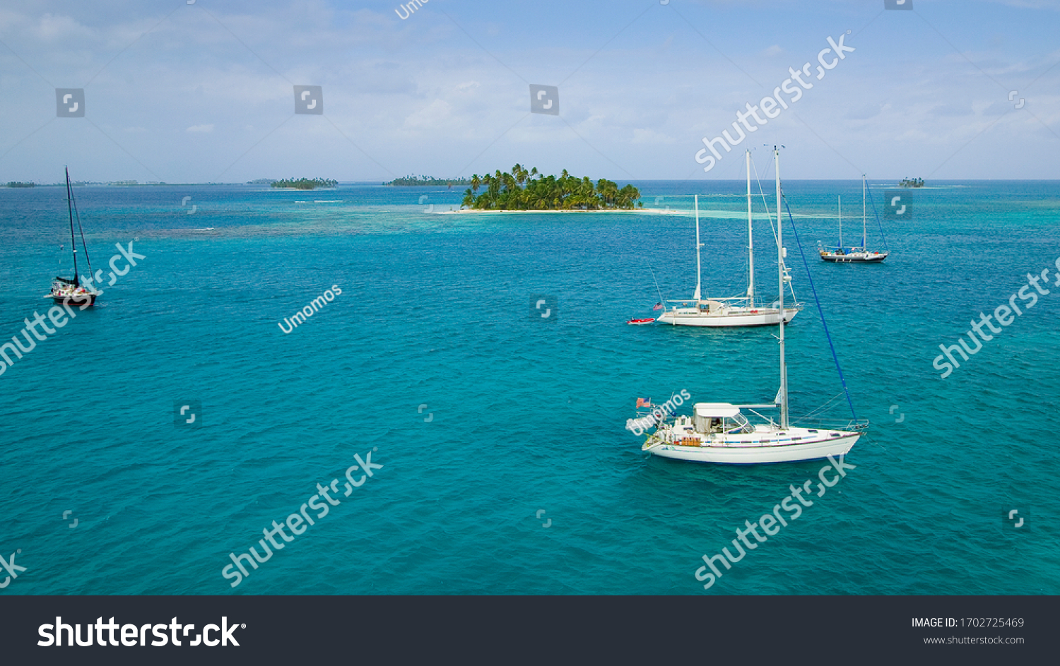 sailing yachts at anchor in the turquoise colored waters of the San Blas Islands, Kuna Yala, Panama #1702725469