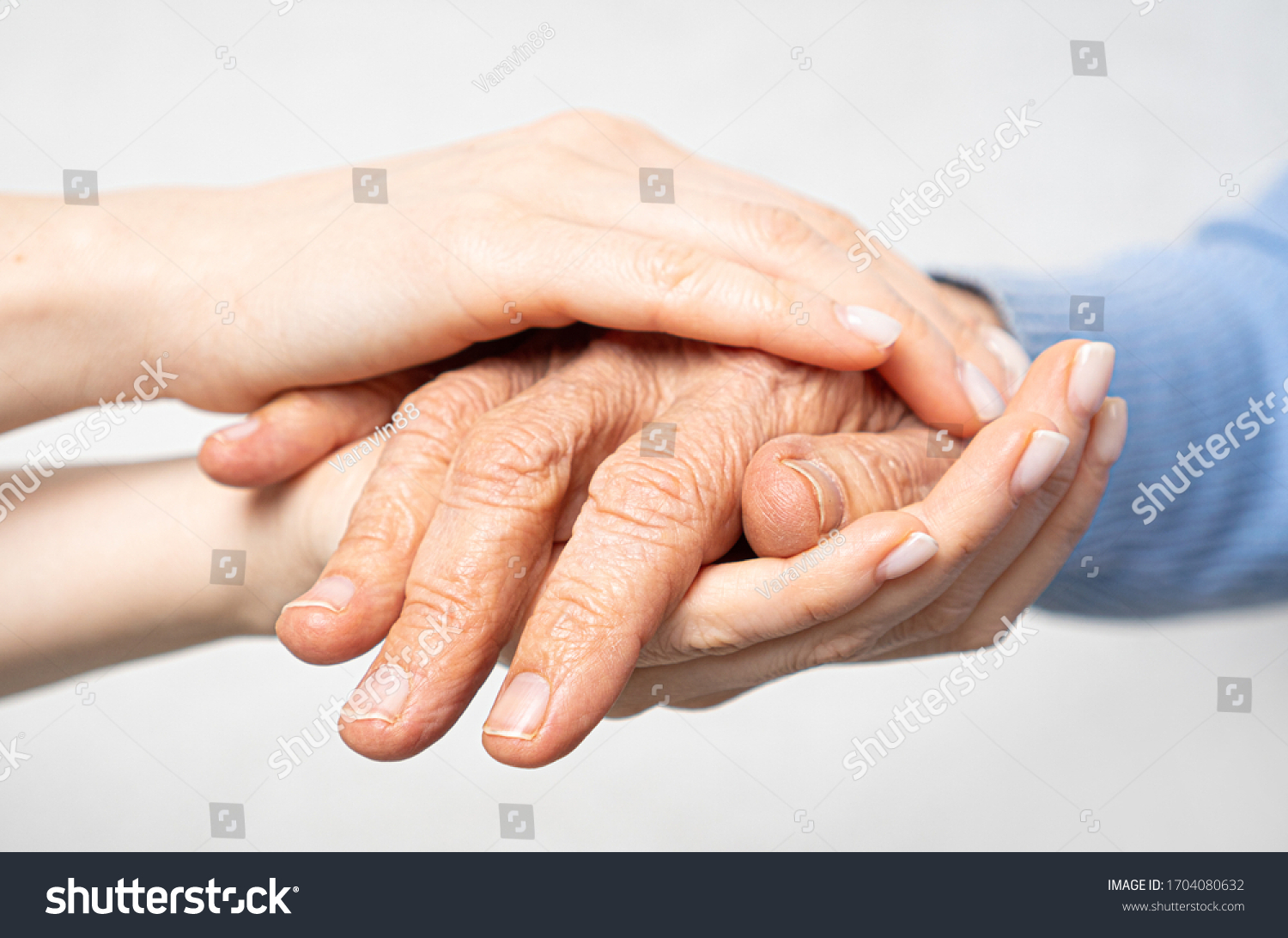 Young hands hold old hands. Support for the elderly concept.  #1704080632