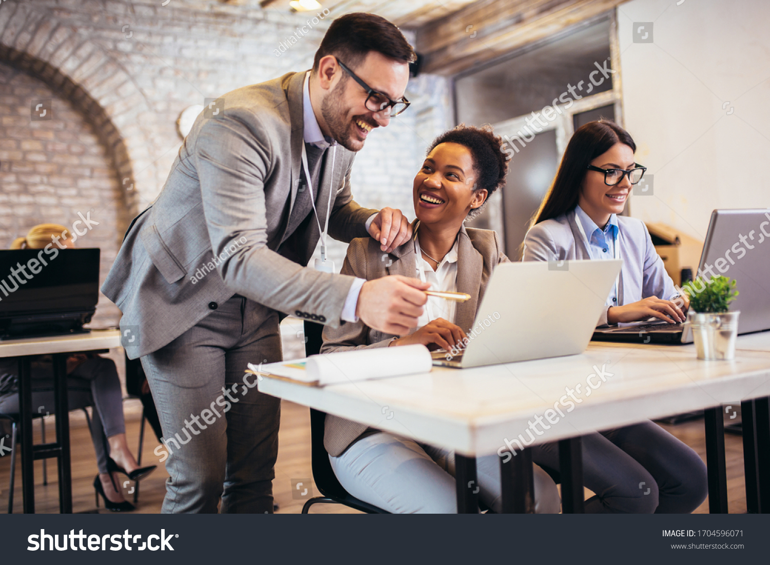 Group of business people working in office and discussing new ideas #1704596071