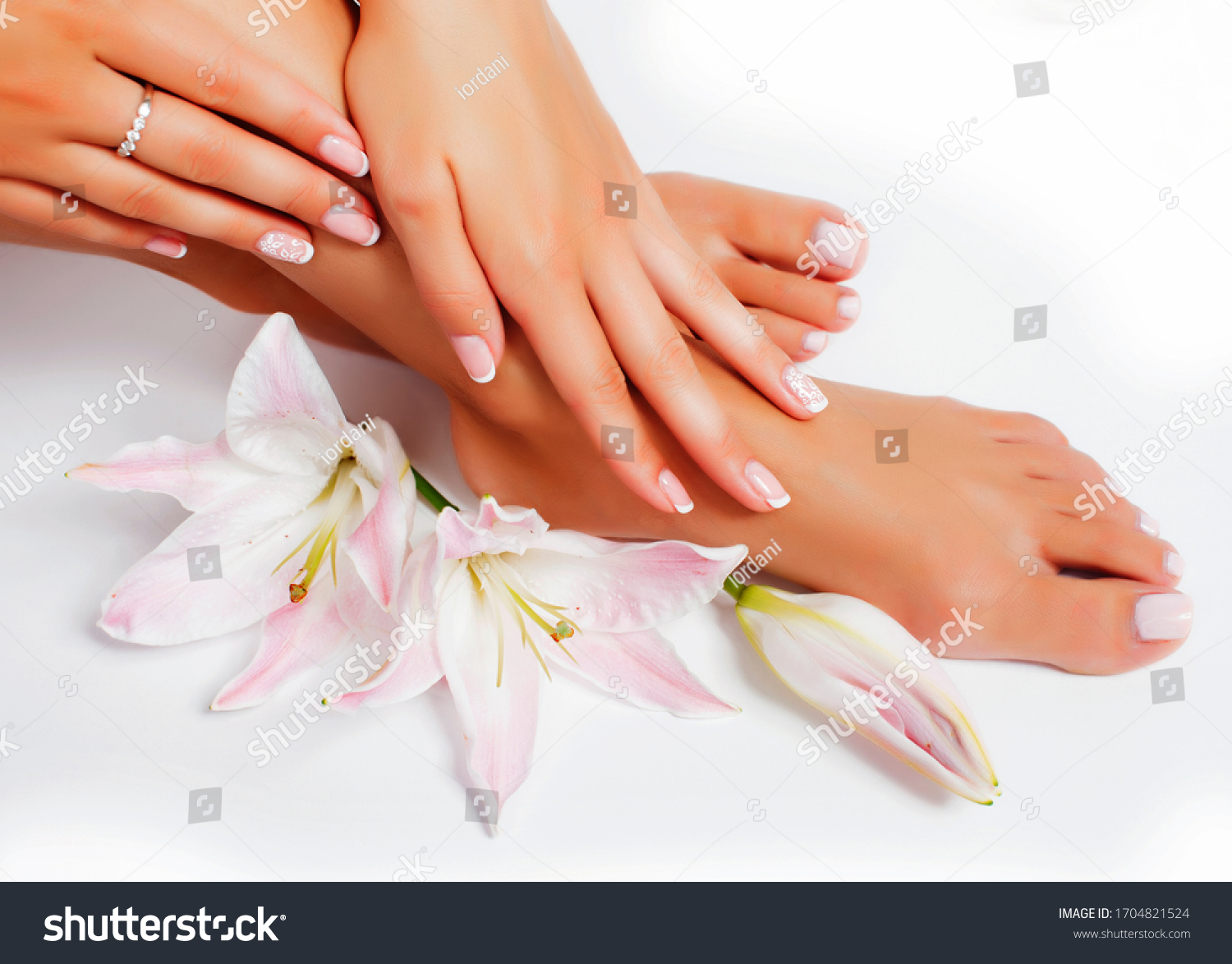 manicure pedicure with flower lily closeup isolated on white background perfect shape hands spa salon #1704821524