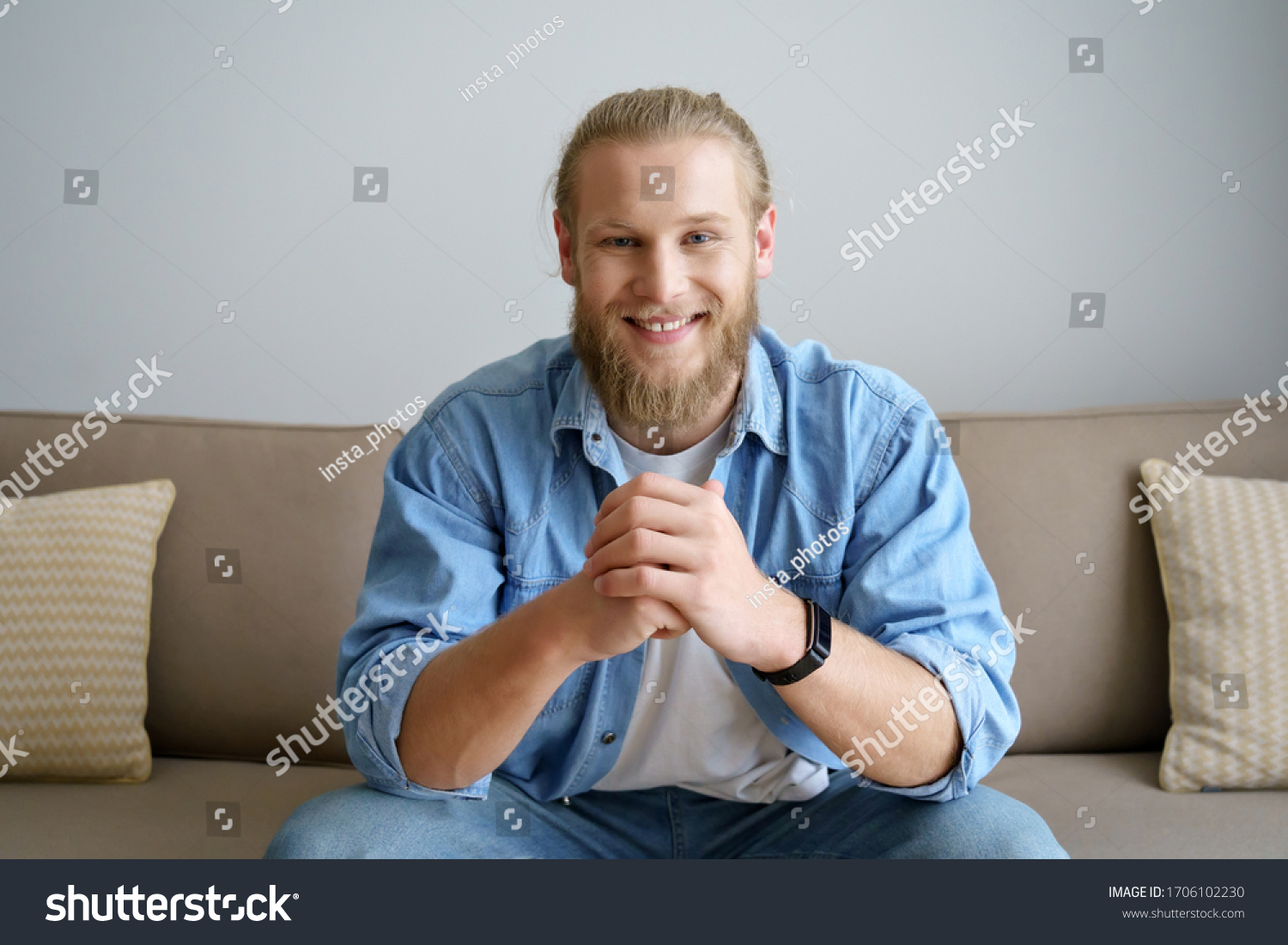 Smiling millennial hipster guy blogger looking at camera video calling, recording vlog. Happy young man distance chatting at home office, streaming sitting on sofa. Headshot portrait. Webcam view #1706102230