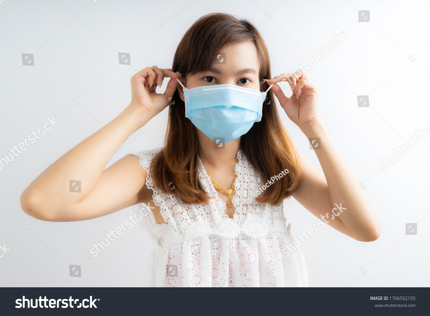 Close up portrait of young woman with medicine health care mask against white white background. CoronaVirus, Covid-19. Asian people #1706552155