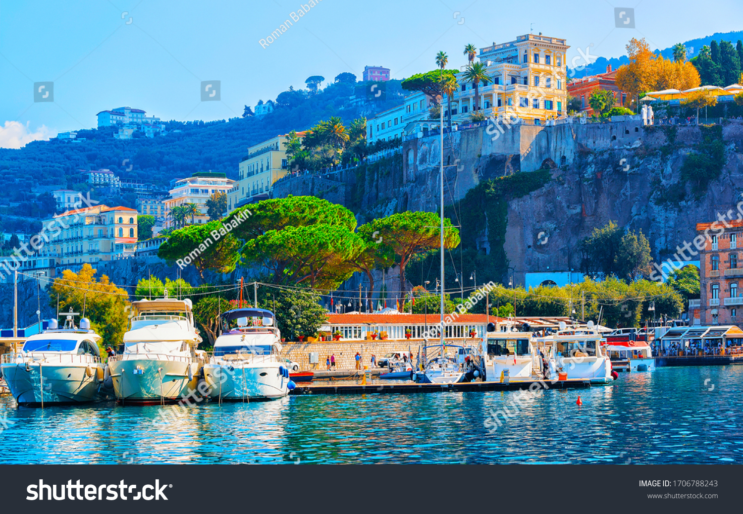 Excursion cruise boats and ships with tourists in luxury Marina Grande port in Sorrento near Naples on Tyrrhenian sea, Amalfi coast, Italy. Italian summer paradise. Mountains on Amalfitana coastline. #1706788243