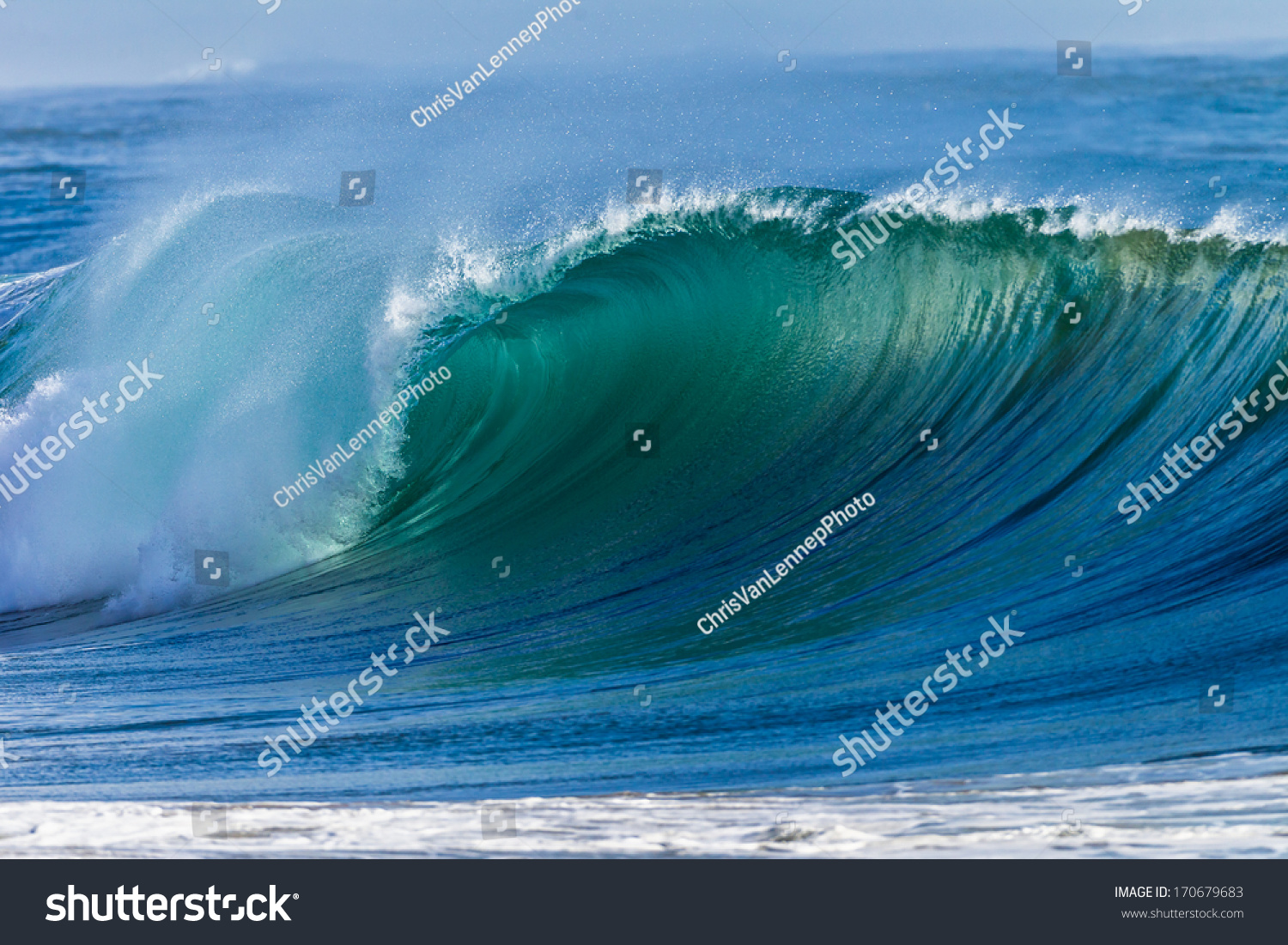 Ocean Wave Curl  Clean ocean wave rolling curling lip crashing on shallow sandbars. #170679683