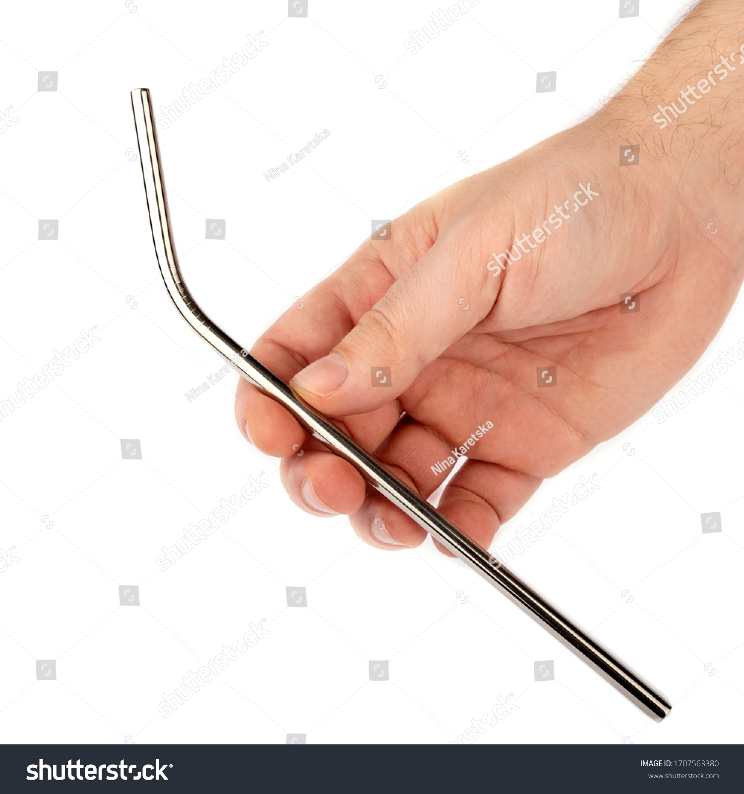 Stainless steel metal straw in hand on a white isolated background. Showing subject on a white background. #1707563380