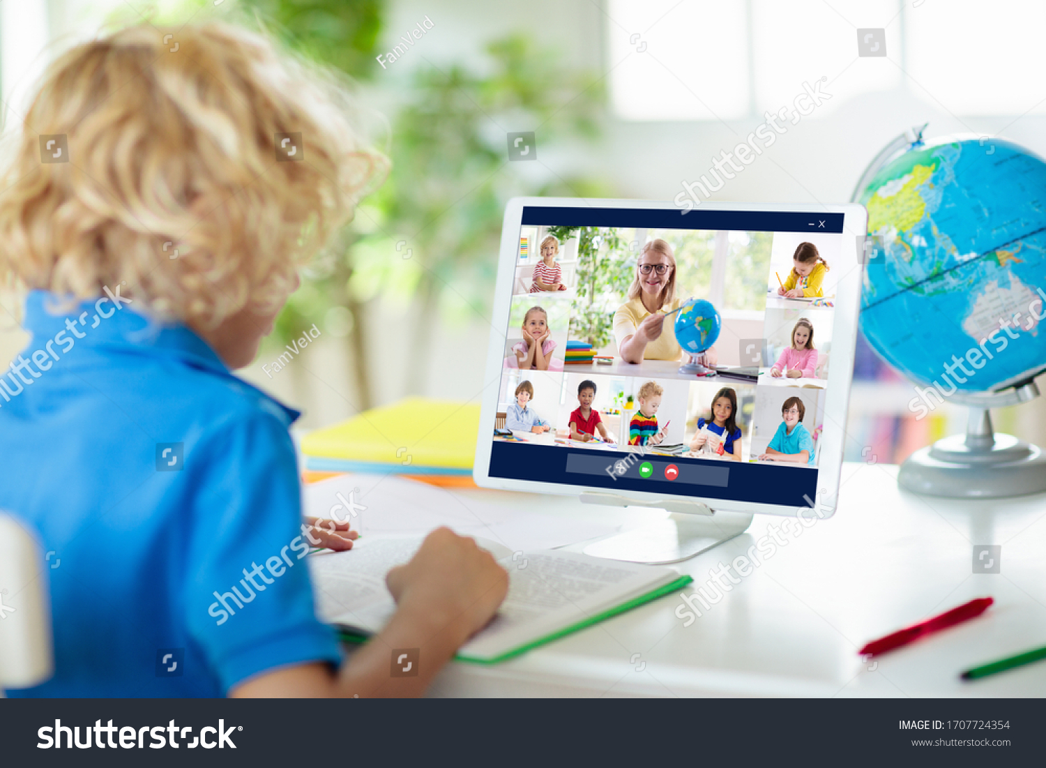 Online remote learning. School kids with computer having video conference chat with teacher and class group. Child studying from home. Homeschooling during quarantine and coronavirus outbreak. #1707724354