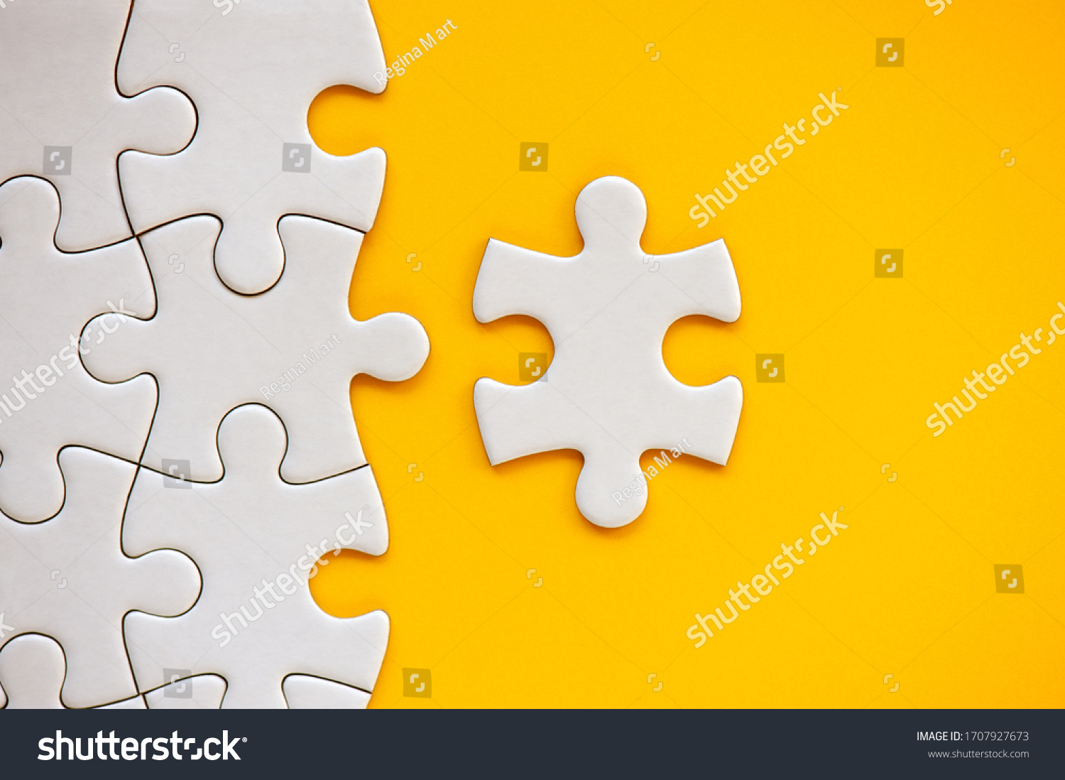 Puzzle pieces on orange background. White square puzzle pieces grid. Business background. Copy space for text, top view, close up. #1707927673