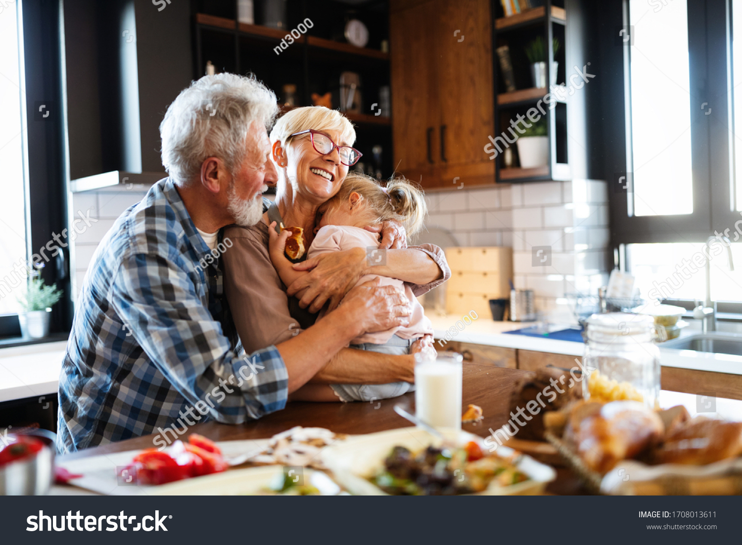 Happy grandchildrens girls having breakfast with her grandparents #1708013611