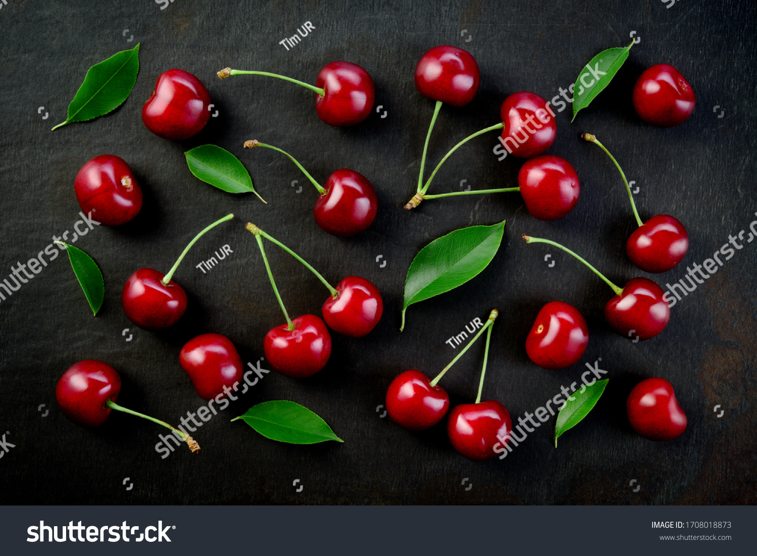 Cherries background. Cherries on black top view. Cherry background. Sour cherry with leaves on black background. #1708018873