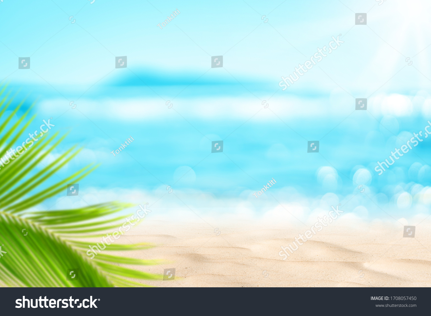 Blur beautiful nature green palm leaf on tropical beach with bokeh sun light wave abstract background. Copy space of summer vacation and business travel concept. Vintage tone filter effect color style #1708057450