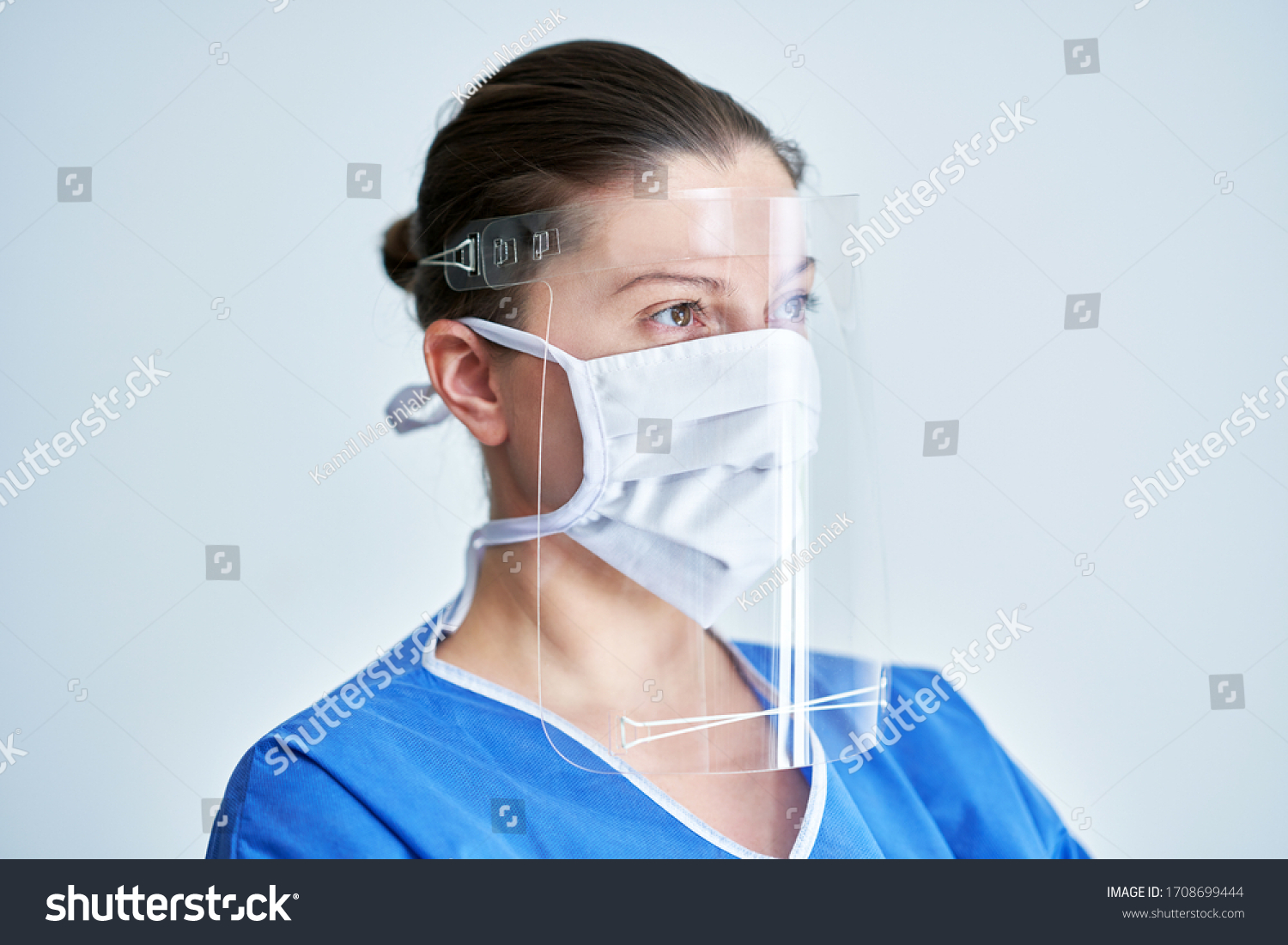 Portrait of female medical doctor wearing protective mask and face shield #1708699444