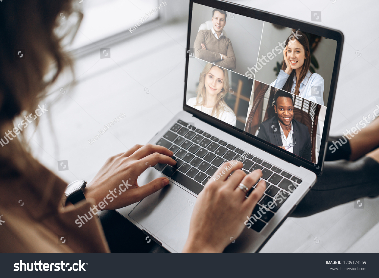 Online business meeting. Business team working from home in a video conference. 
The girl communicates via video call communication using laptop with her business colleagues about the future strategy #1709174569