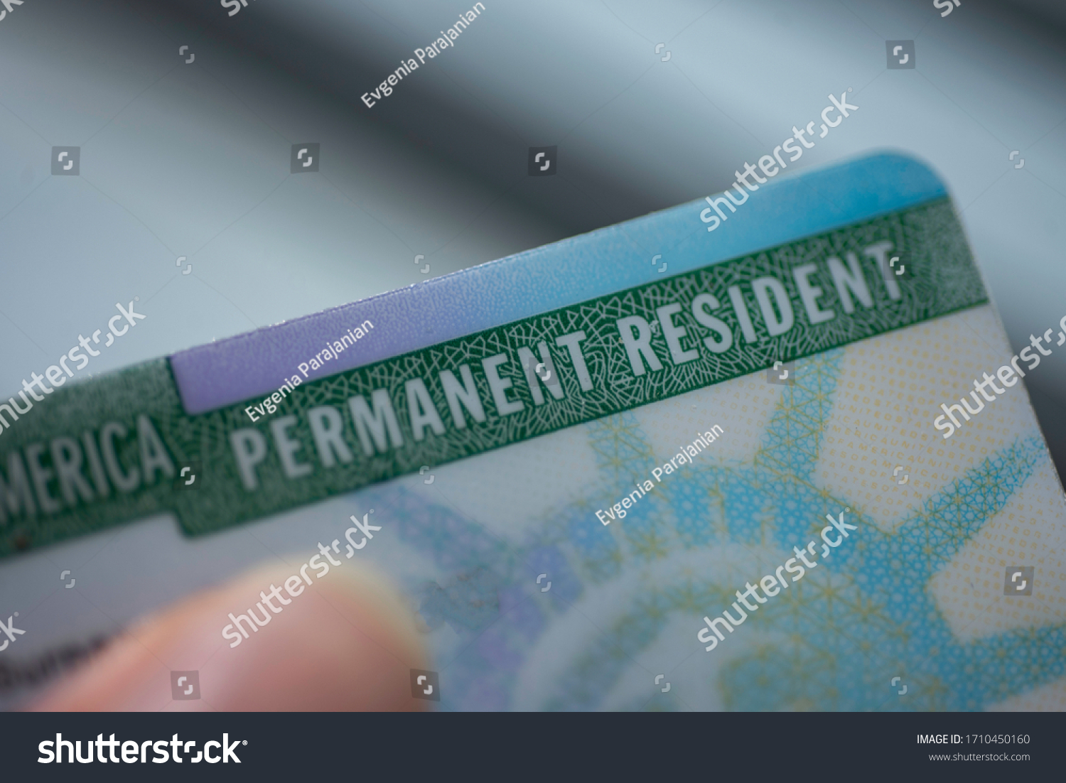 Close up view of Fragment of Permanent resident card (Green) card of USA on blurred background. 