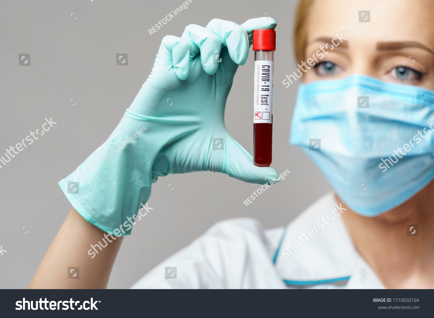 medical doctor nurse woman wearing protective mask and gloves - holding virus blood test #1710650104